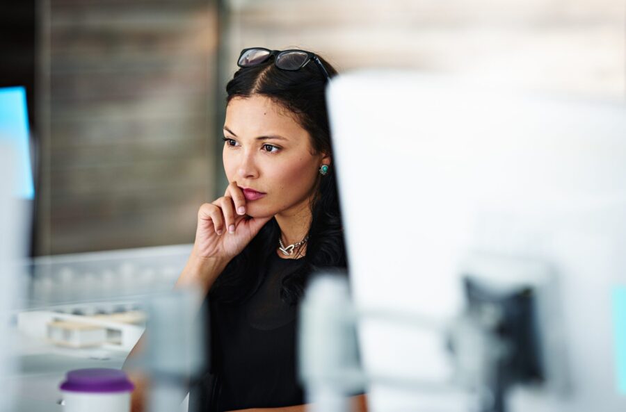 woman on computer contemplating