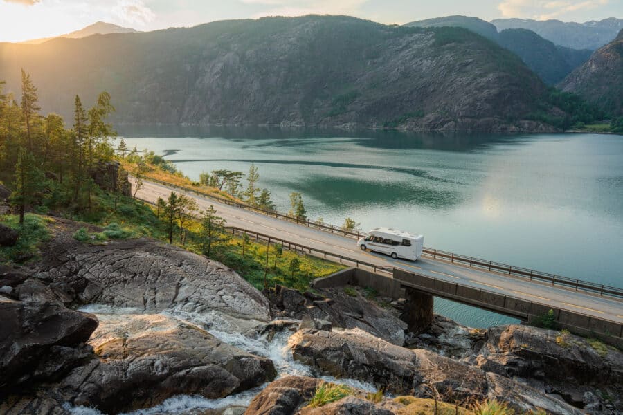 Caravan On Road Near Låtefossen Waterfall In Norway