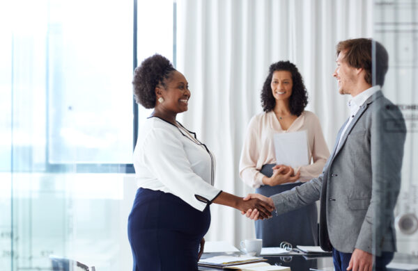 Shot of two businesspeople shaking hands in an office