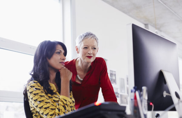 how do you write a human resources business plan Mature business woman mentoring younger employee.