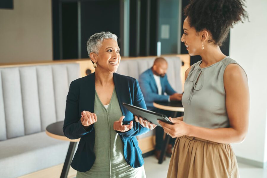 Communication, consulting and planning, business women meeting in the work lobby. A woman in leadership, ceo, team leader or coaching mentor, collaboration and motivation for office employee success