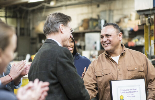 Worker receiving award in workshop