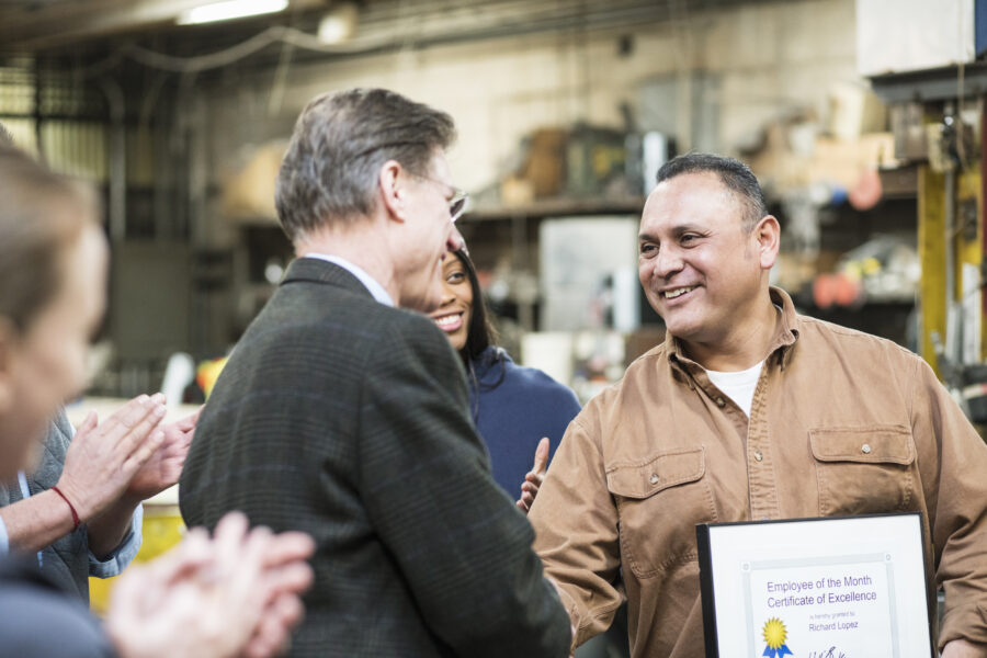 Worker receiving award in workshop