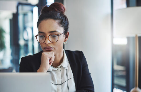 Shot of a young businesswoman using a laptop in a modern office