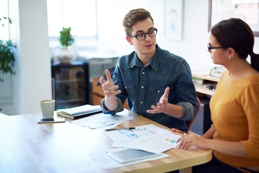 Cropped shot of two coworkers having a discussion in the office