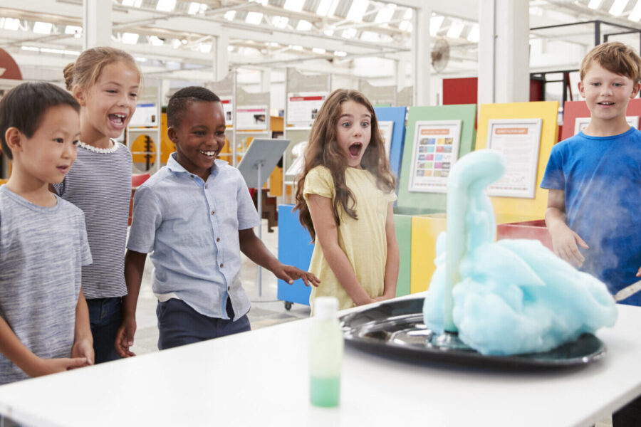 Kids Having Fun Watching An Experiment At A Science Centre