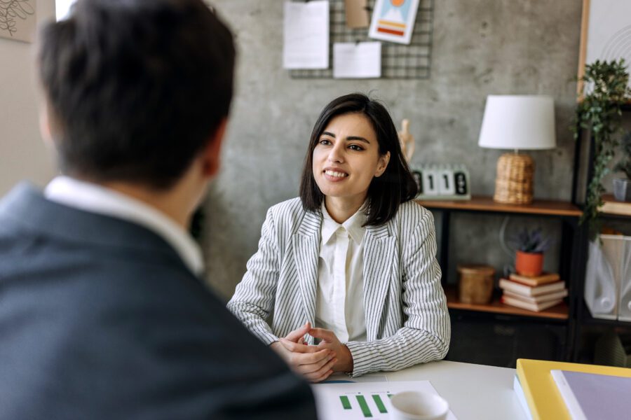 Young businesswoman talking with her colleague in the office