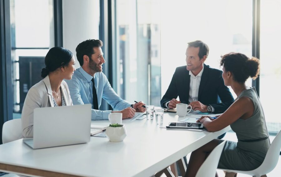 Business, teamwork and meeting in office with manager, collaboration and startup agency. Group, employees and corporate leadership at table for strategy, planning ideas and diversity of management