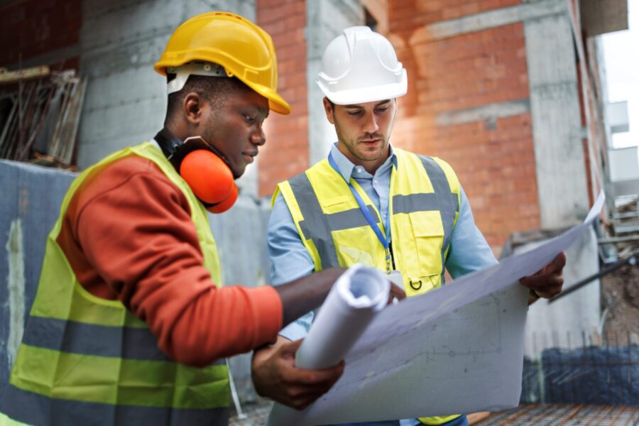 Two construction workers discussing work at construction site