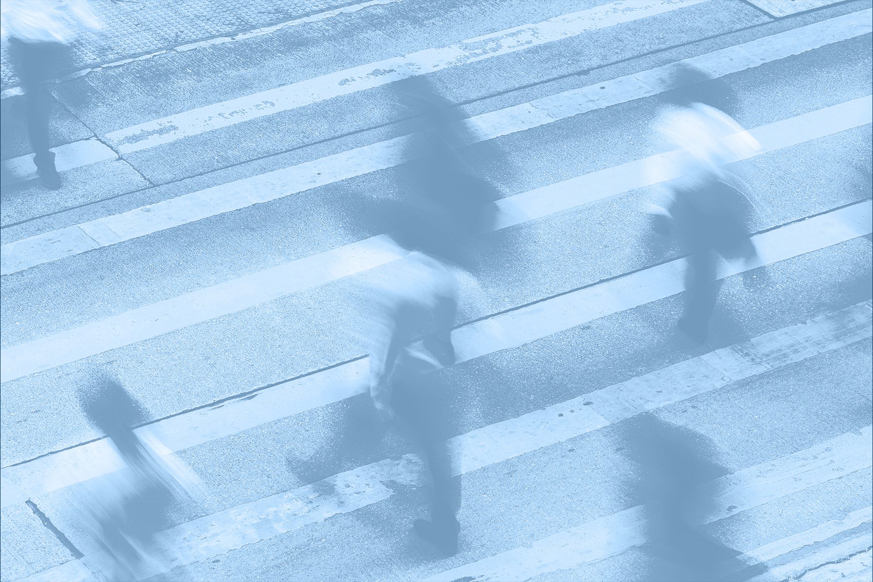 People walking across the street on a crosswalk