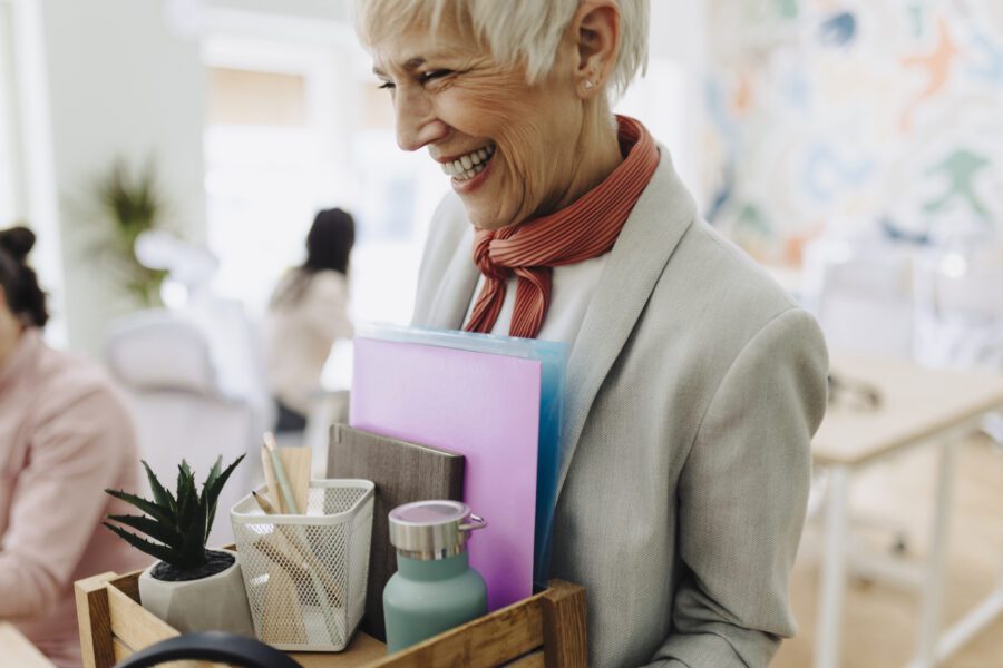 Businesswoman packing personal company belongings after deciding on a resignation or change of job and completing offboarding