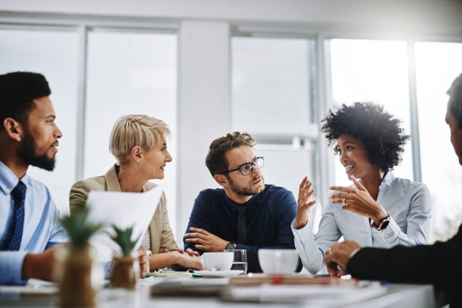 Business professionals engaged in a discussion at a table in their office
