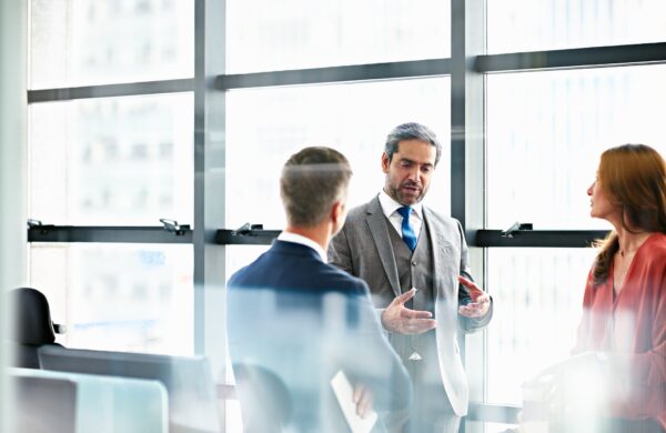 Business managers discussing plans for company in modern office