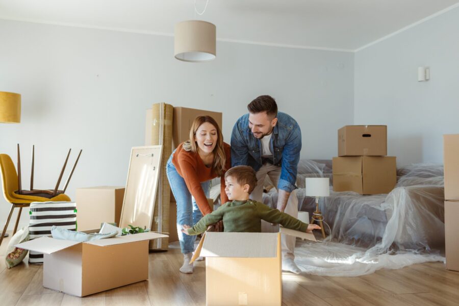 Playful happy family having fun moving into new apartment