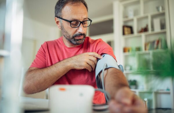Man preparing to check his blood pressure at home