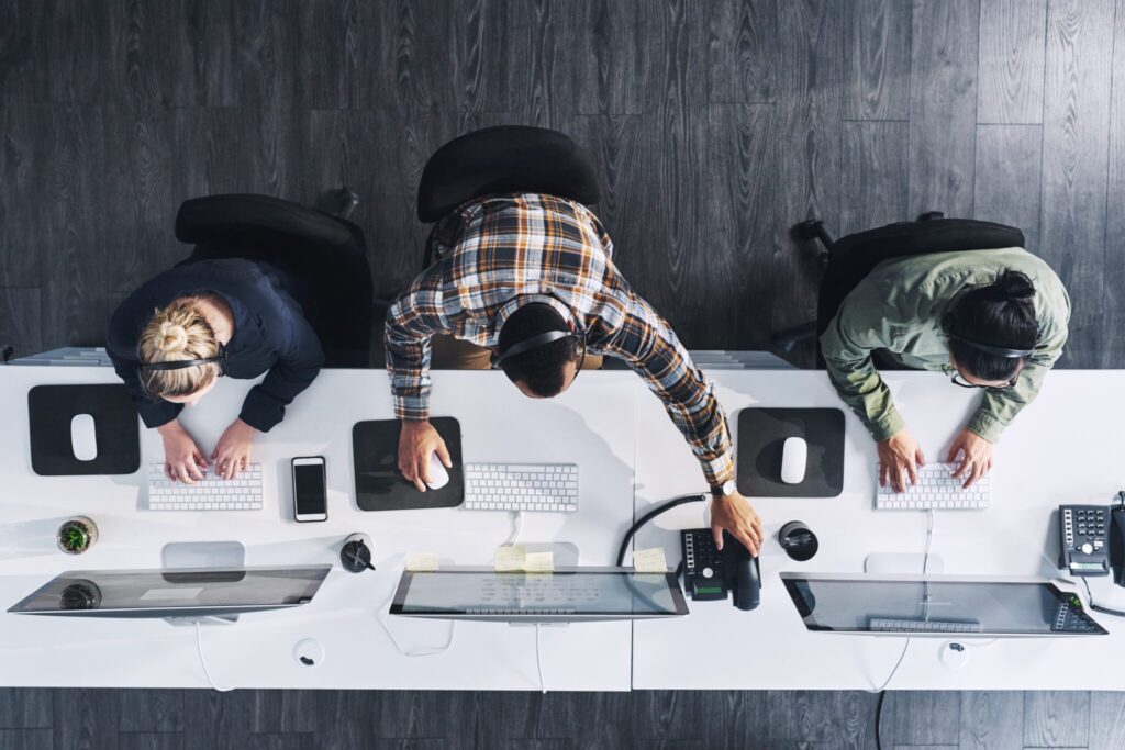 High angle shot of a group of business people working on computers in a modern office