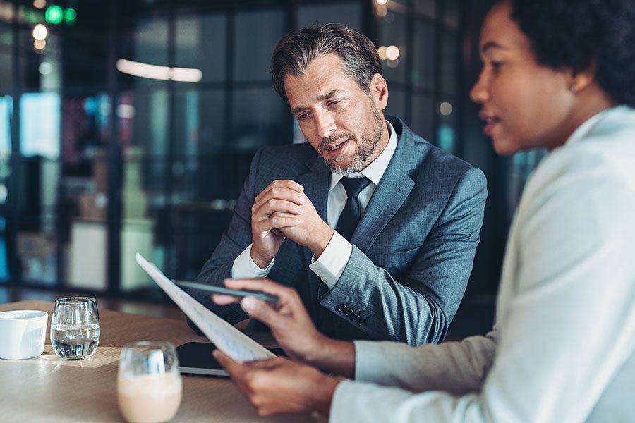 Two business persons looking in a document in the office