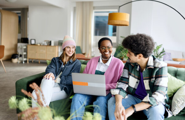 Group of Millennial employees in a modern office brainstorming new ideas during a business team meeting