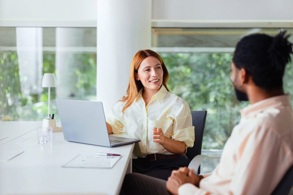 Two colleagues engaging in a friendly and productive business meeting in a modern office