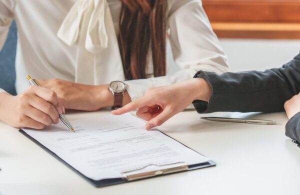Two business professionals looking over contracts and business documents