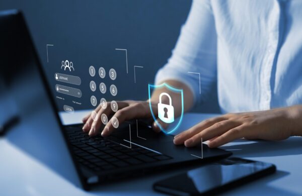 Man typing on laptop computer with digital representation of locked personal information and cyber security