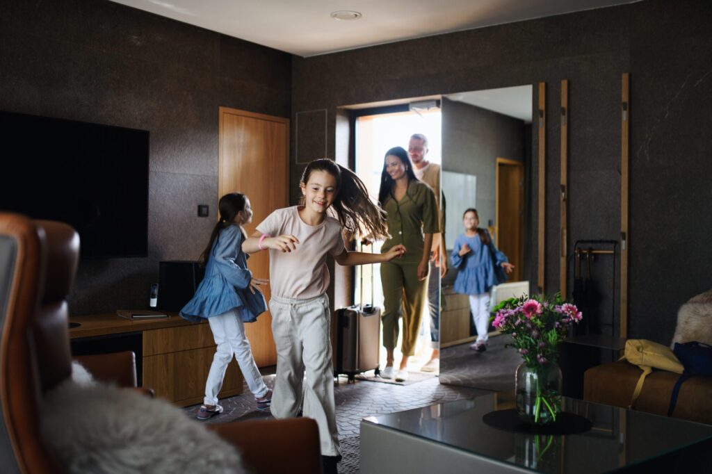 Young family with two children entering their room at a hotel
