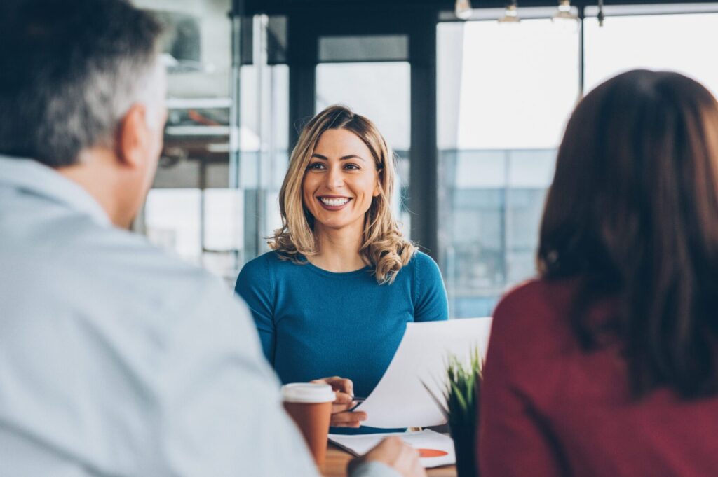 Couple discusses their coverage needs with their insurance agent in a professional setting